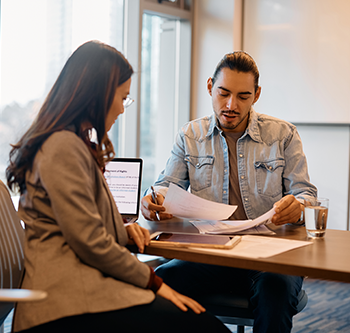 man and woman discussing paperwork