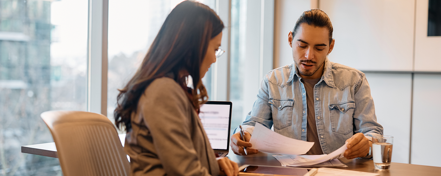 man and woman discussing paperwork