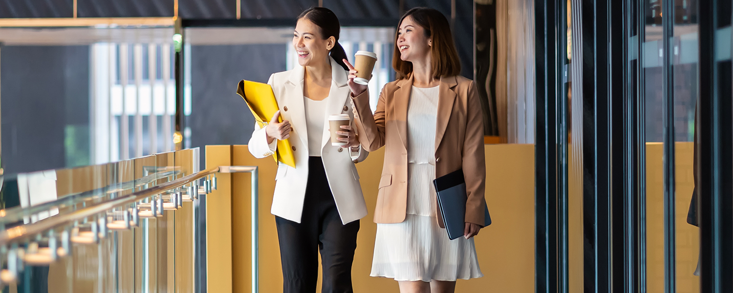 two professional women walking and talking