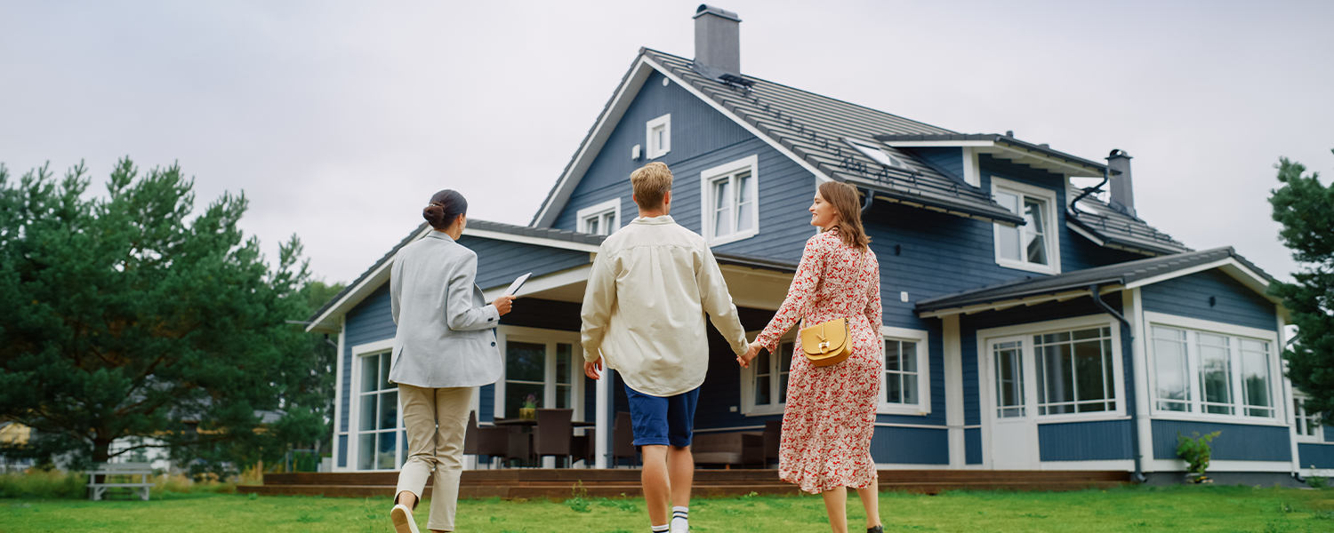 couple and realtor walking towards home
