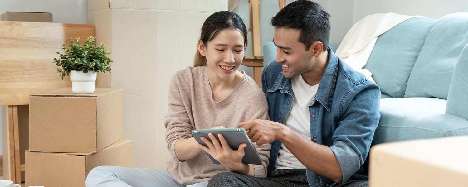 man and woman looking at tablet together
