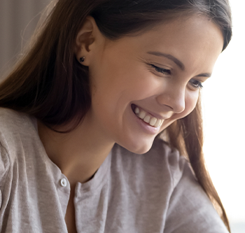 woman smiling at paperwork
