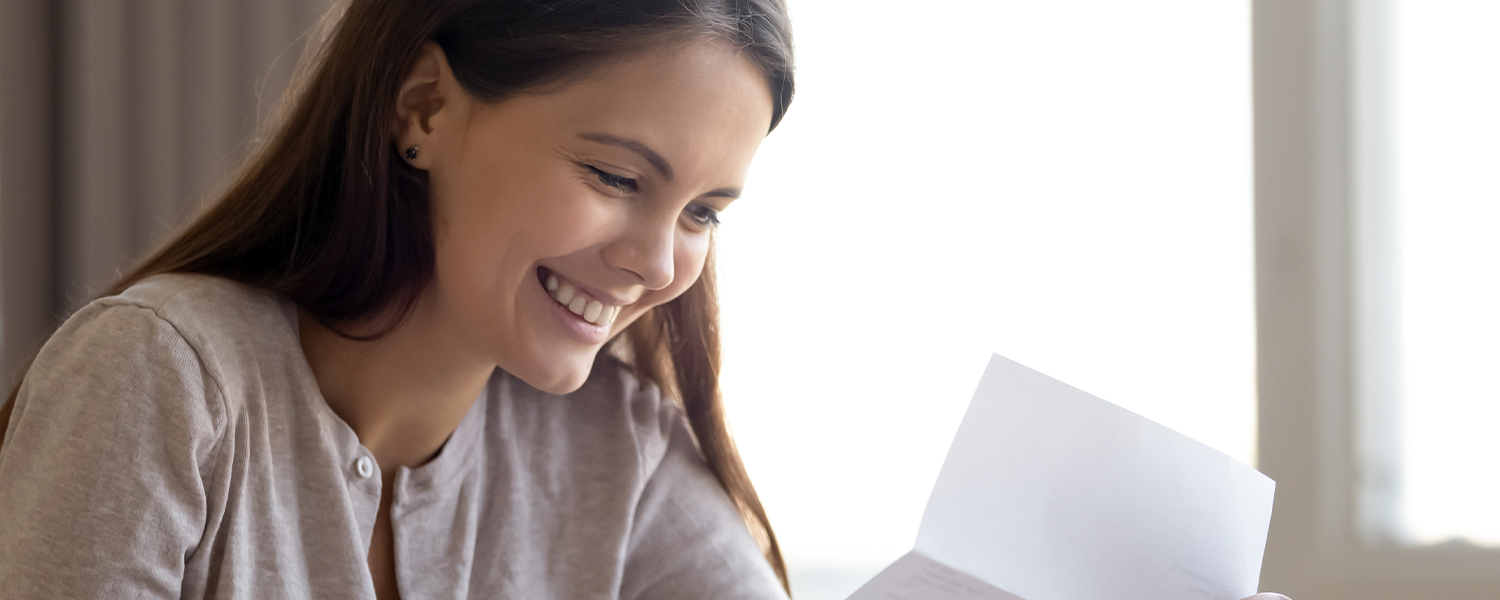 woman smiling at paperwork