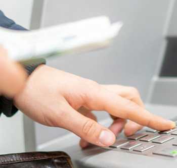 close up of hand using ATM