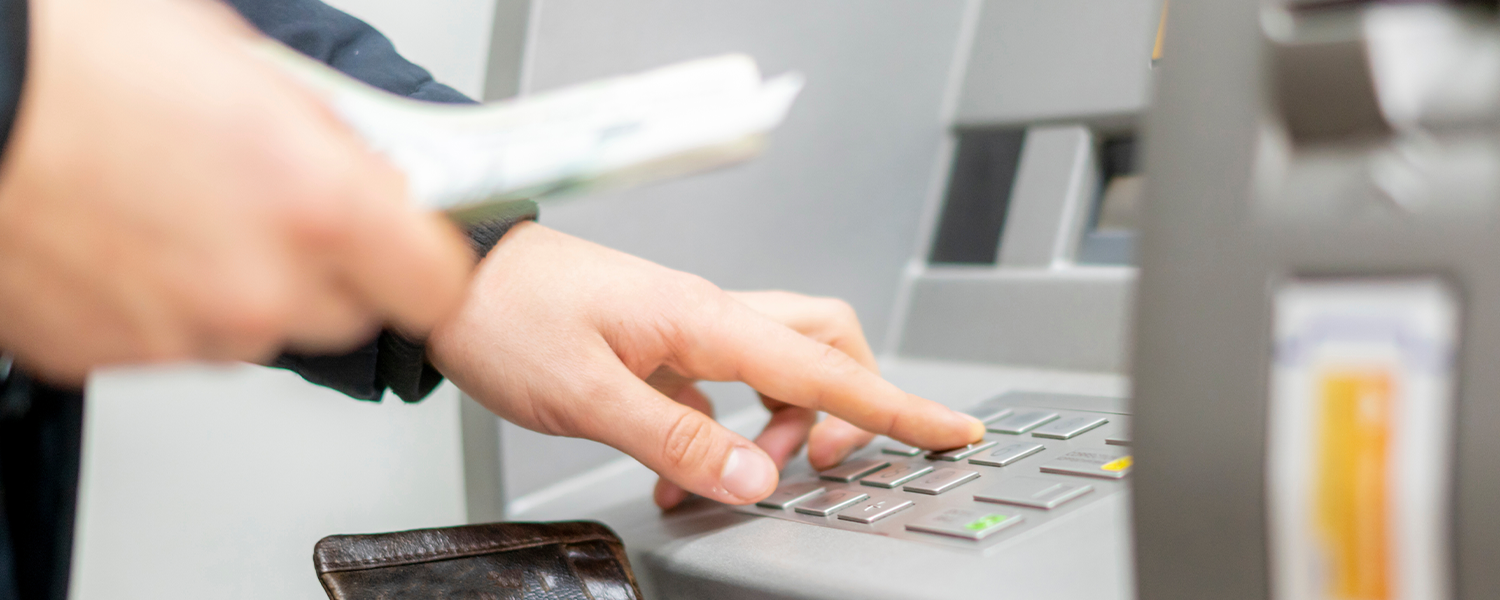 close up of hand using ATM