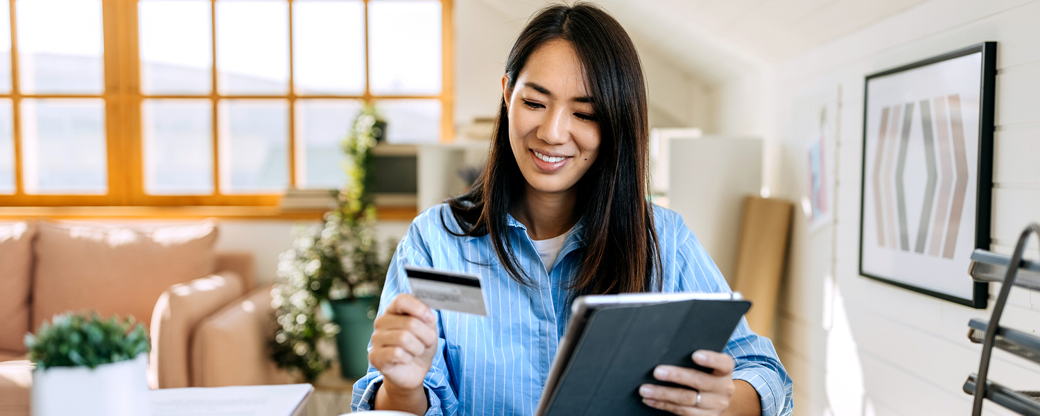 woman looking at her credit card
