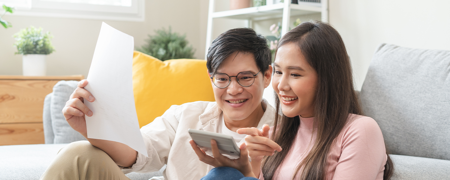 man and woman looking at phone