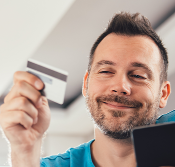man looking at credit card
