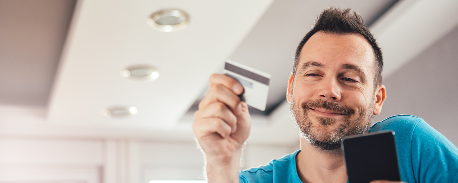 man looking at credit card