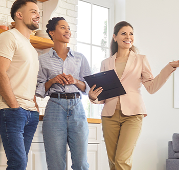 woman showing house to couple