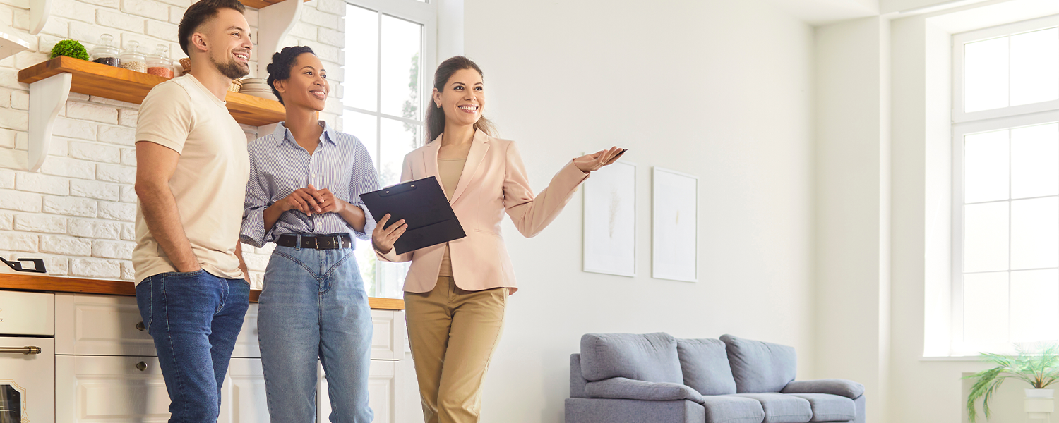 woman showing house to couple