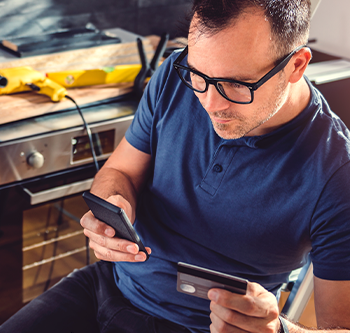 man looking at credit cards