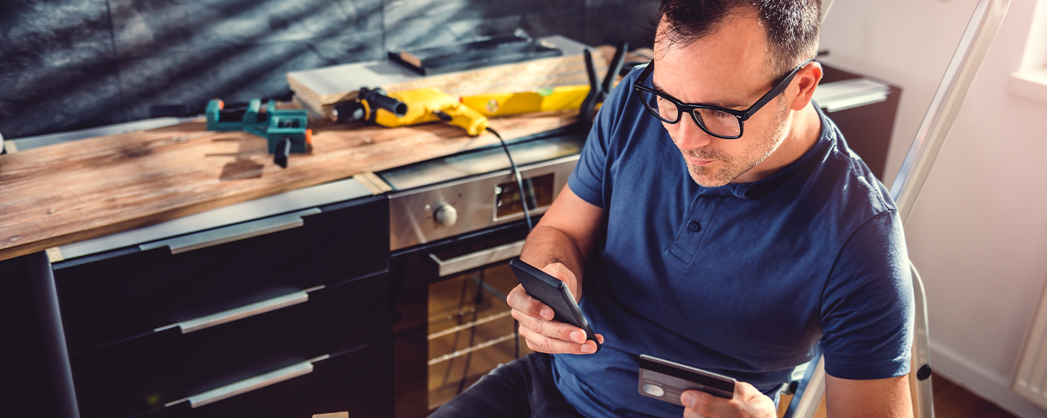 man looking at credit cards