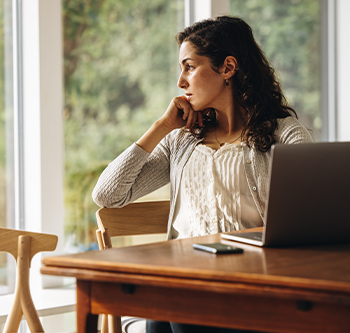 woman looking wistfully out window