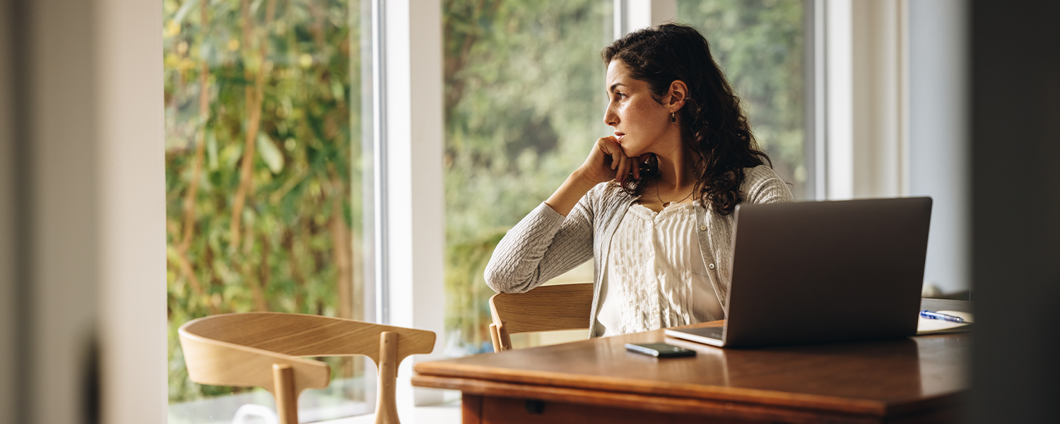 woman looking wistfully out window