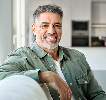 man leaning against his couch