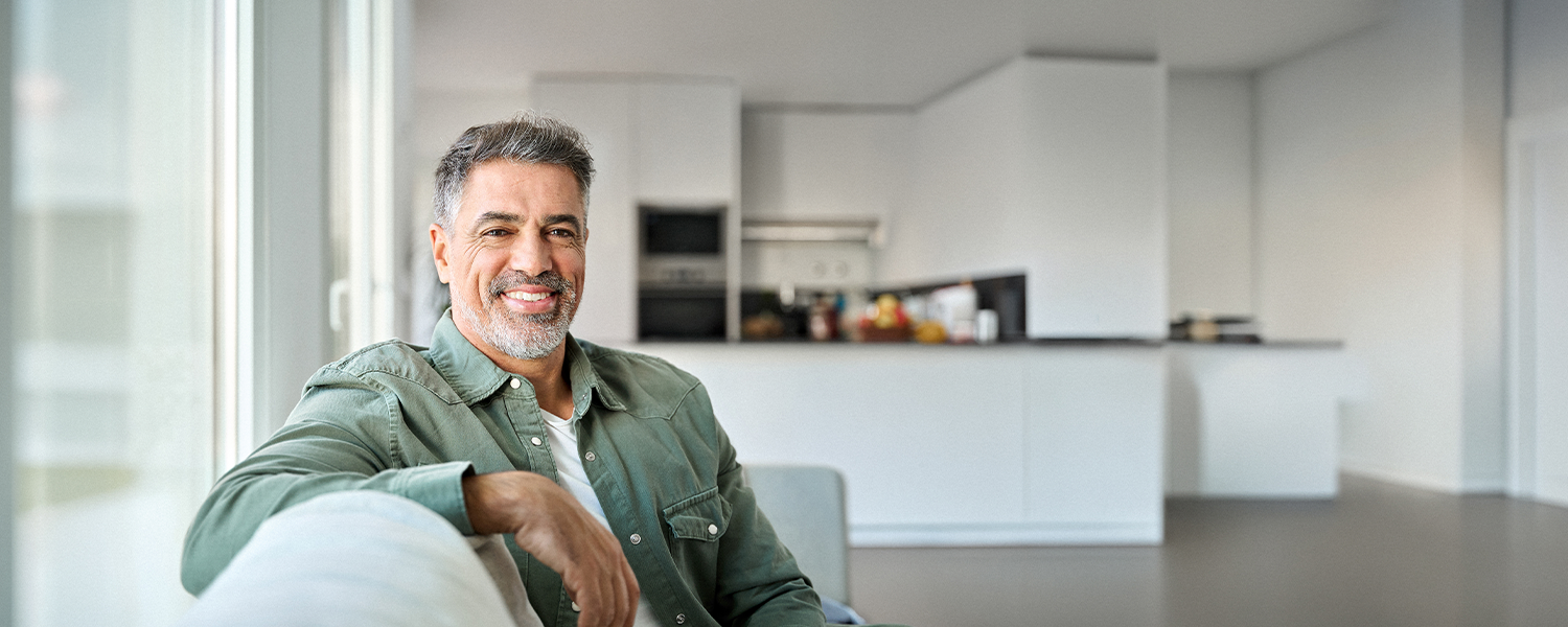 man leaning against his couch