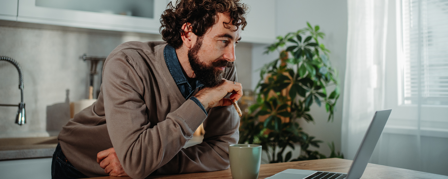man looking at his computer