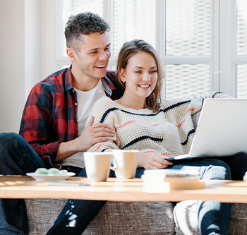 man and woman looking at computer together