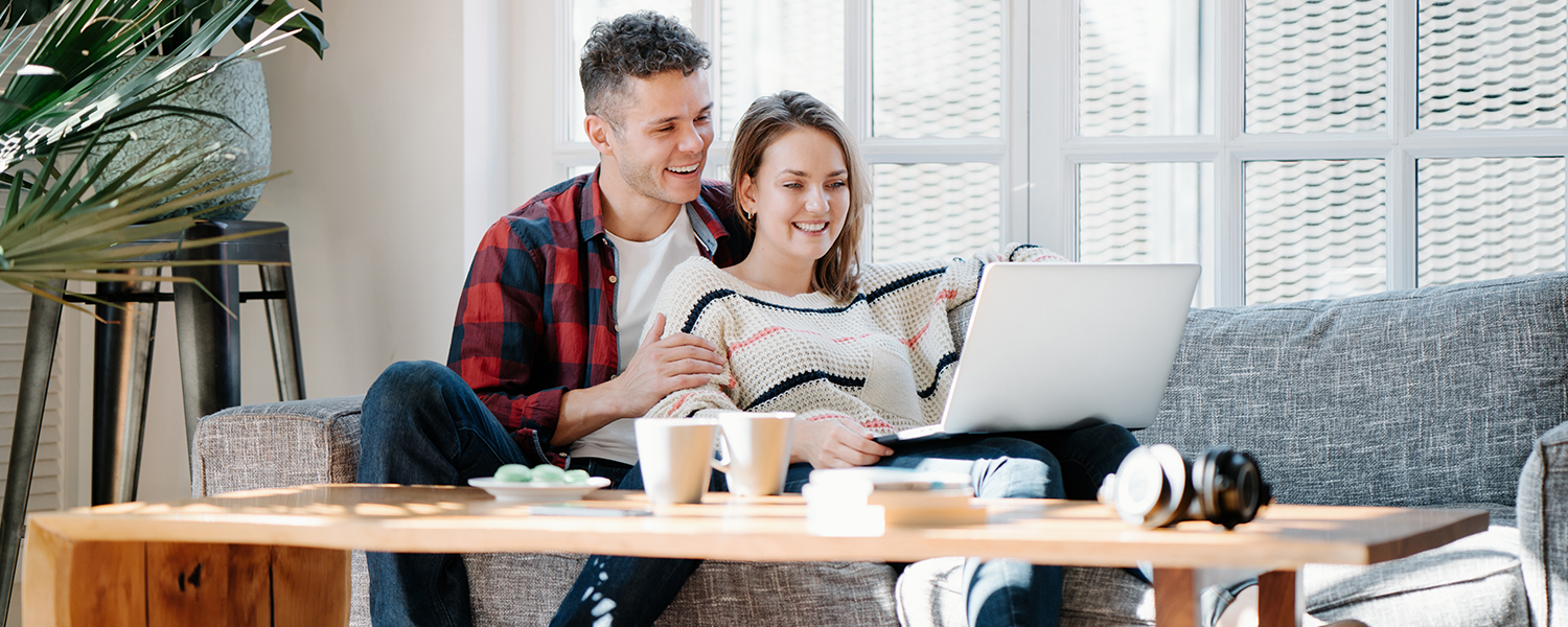man and woman looking at computer together