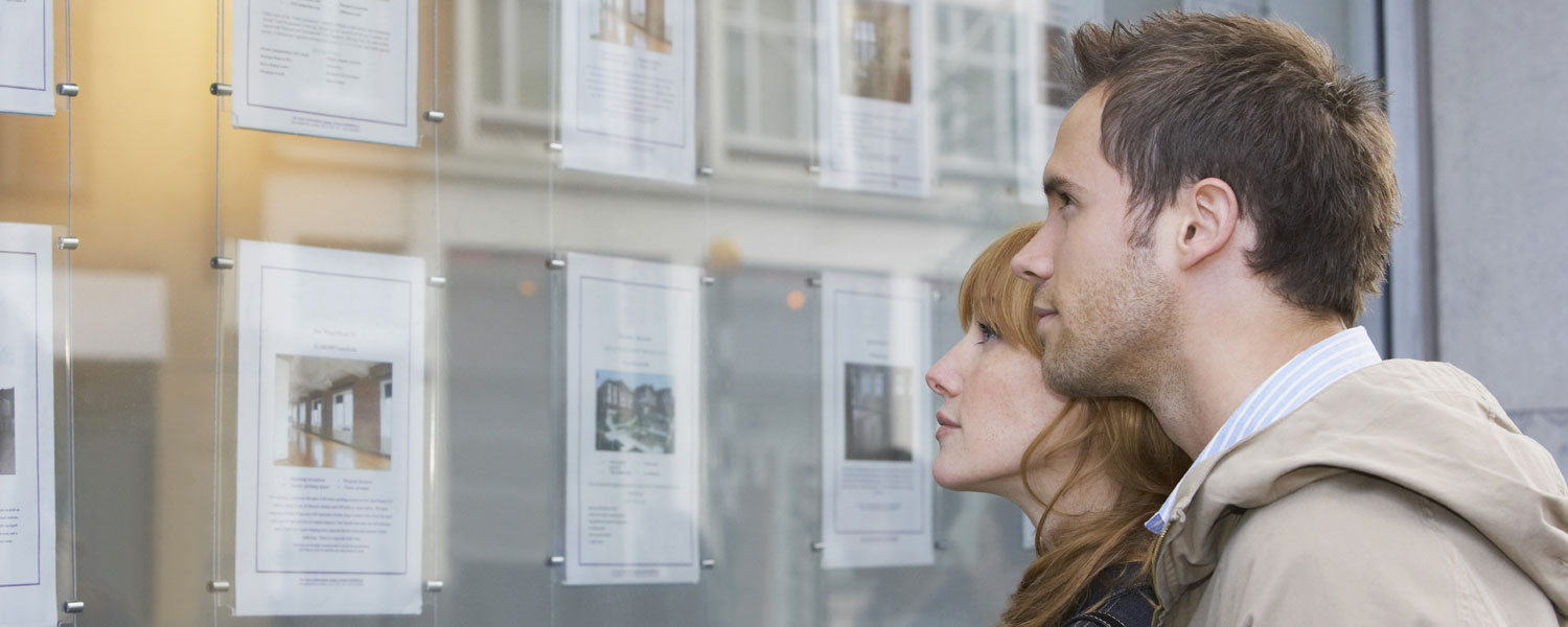Man and woman looking at homes together