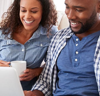 Man and woman looking at laptop together