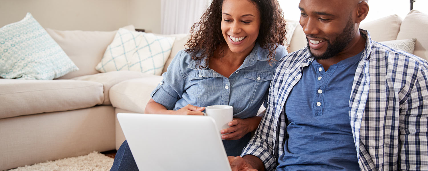 Man and woman looking at laptop together