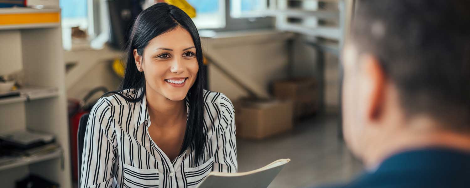 Woman smiling and holding papers