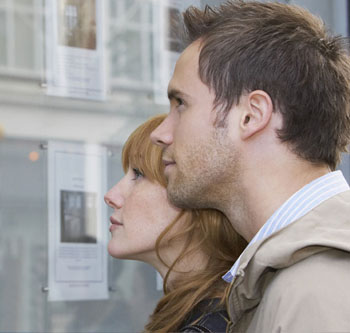 Man and woman looking at homes together