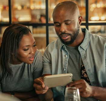 Man and woman looking at a smart phone together