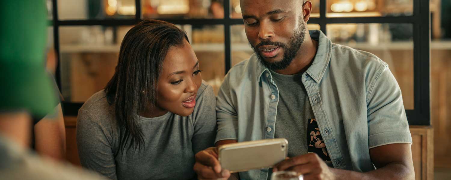 Man and woman looking at a smart phone together