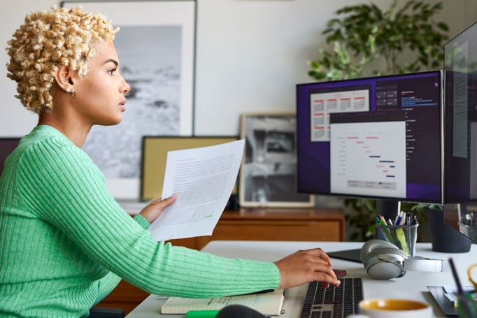 Woman in green sweater working at her computer