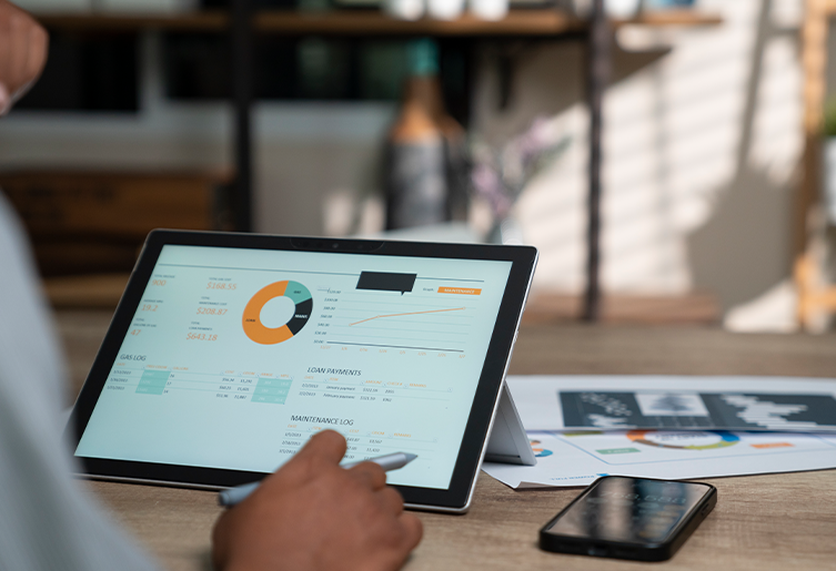 Person looking at tablet showing  their cash management dashboard