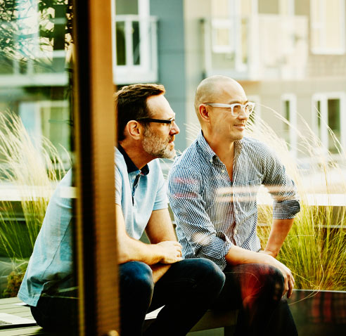 Two men sitting outside and chatting