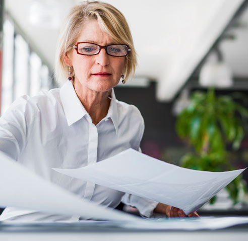 Woman in white shirt organizing some paperwork