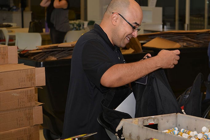 Volunteers filling backpacks