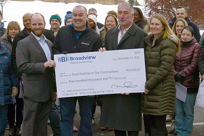 Broadview President and CEO holding a donation check 