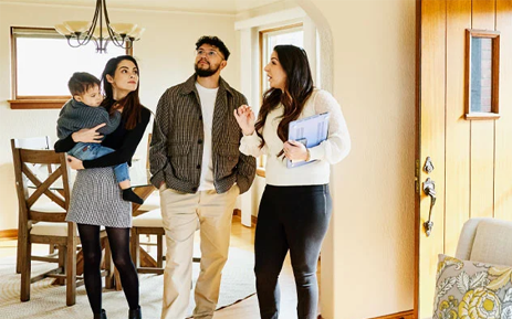 Family looking at a home with a realtor