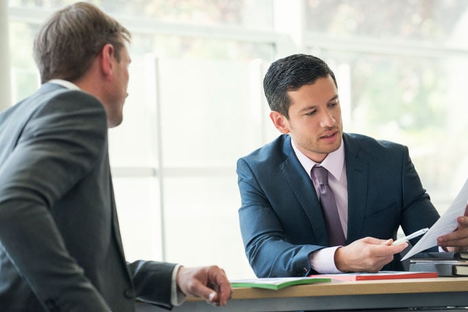 Two men looking at a paper