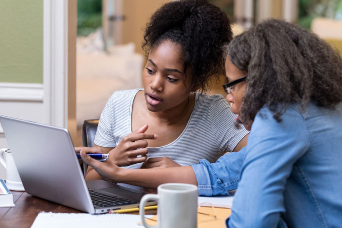 Two women looking at a computer screen