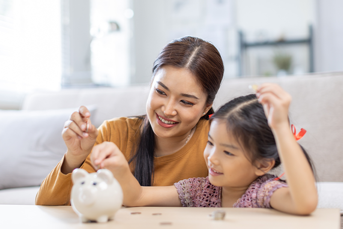 mom and daughter using a piggy bank
