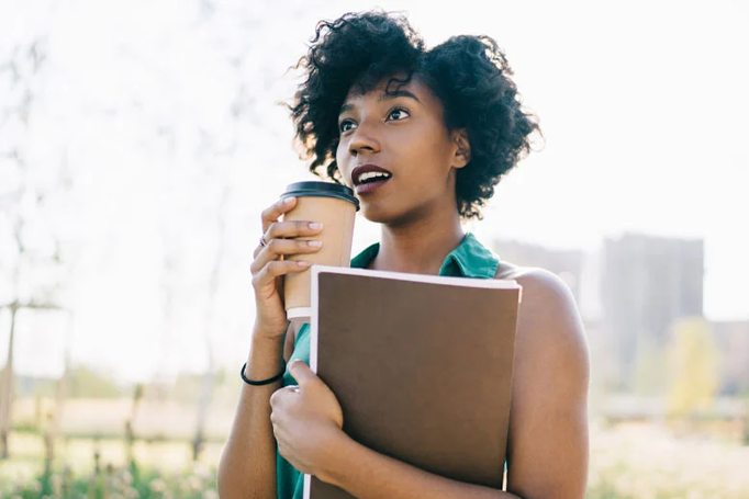 woman standing and drinking coffee