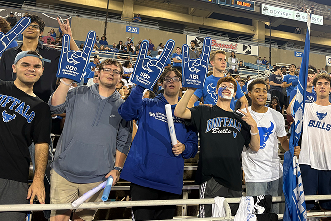A group of University at Buffalo students cheering at a football game