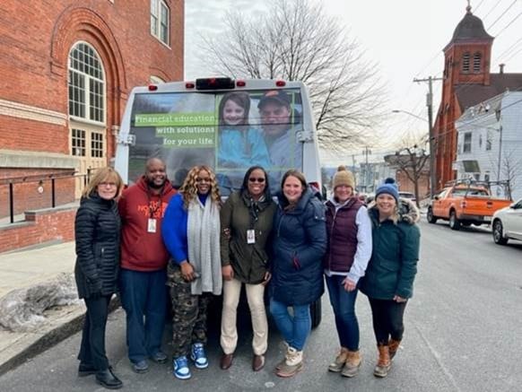 Group of people smiling in front of van in Albany, NY