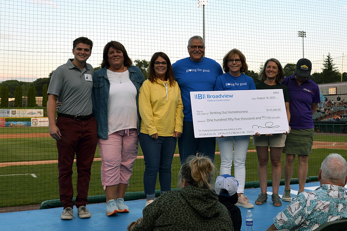 Group of people accepting large check