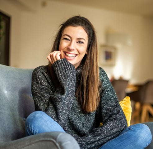 Woman sitting down and smiling