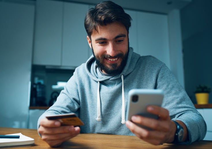 Man holding his card and phone