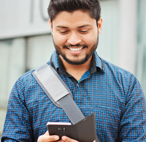 Man looking at his phone and smiling