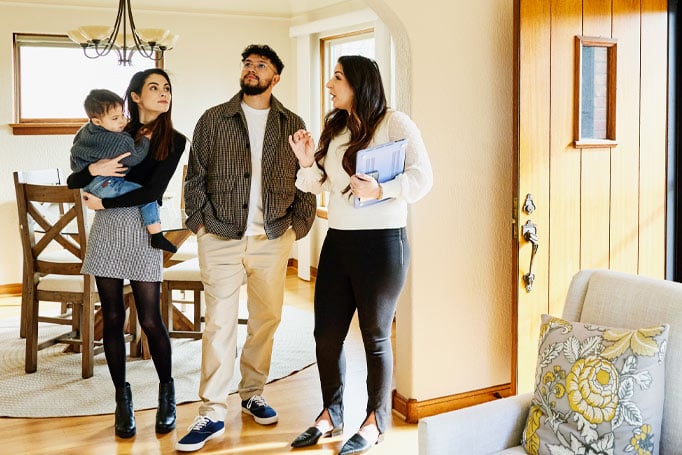 Family looking at a house with agent