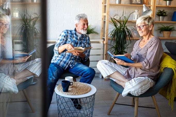 Couple sitting together with books